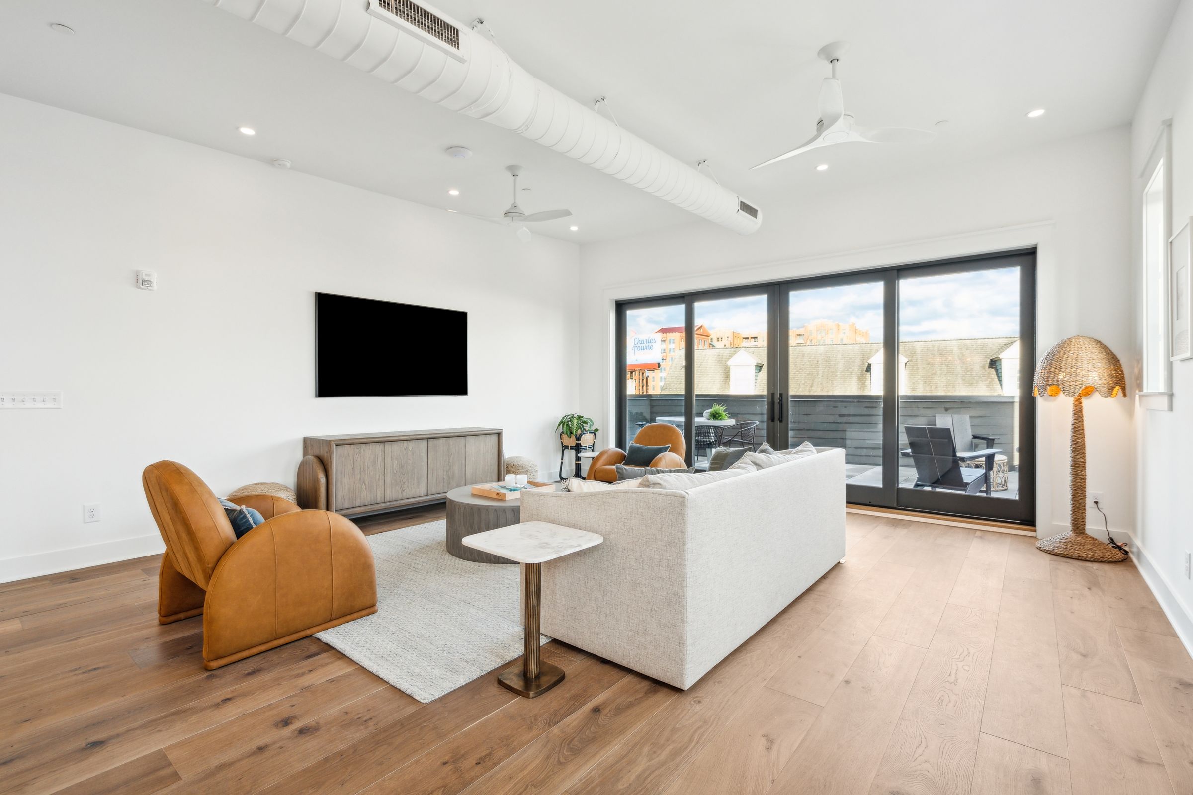 Living room with floor-to-ceiling glass doors opening to the terrace